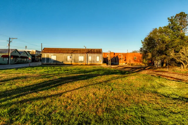 a view of a swimming pool with an outdoor seating and a yard