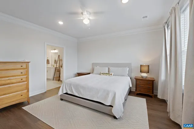 a bedroom with a large bed and a flat screen tv