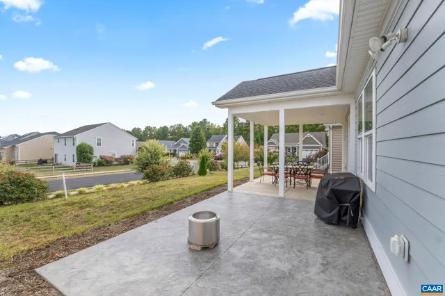 a view of a patio and backyard of the house
