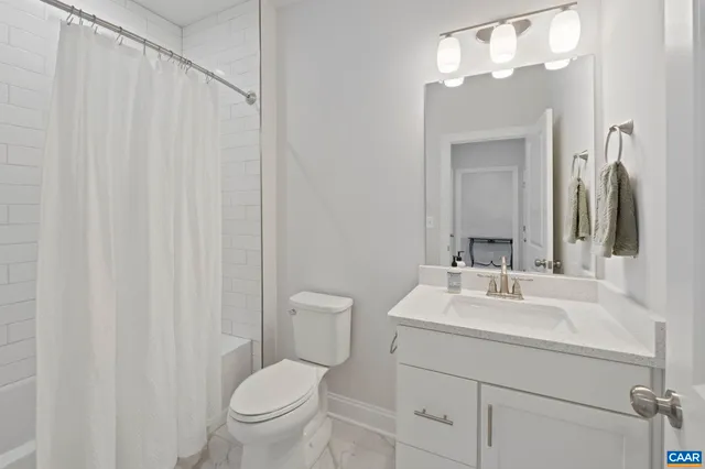a bathroom with a toilet a sink and a mirror