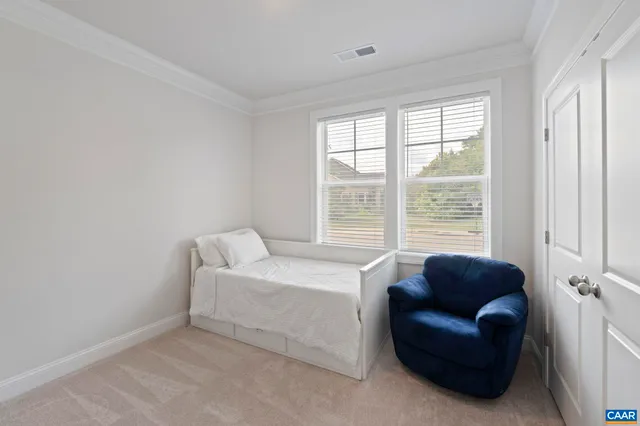 a bedroom with furniture and a window