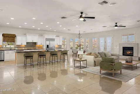 a living room with lots of furniture and kitchen view