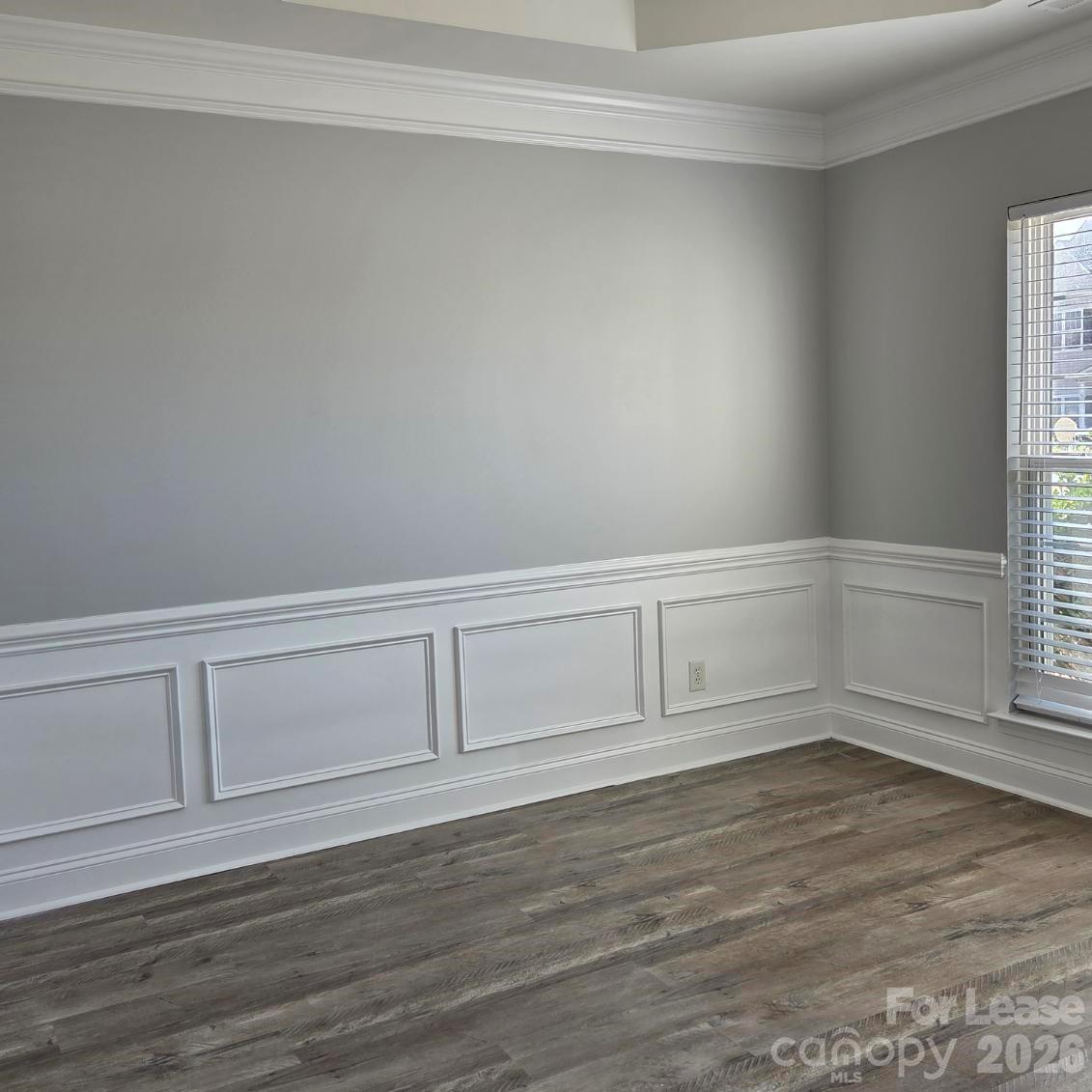 5840 Timbertop Lane Charlotte, NC 28215 - Photo 11 of 34 a view of an empty room with wooden floor and cabinet