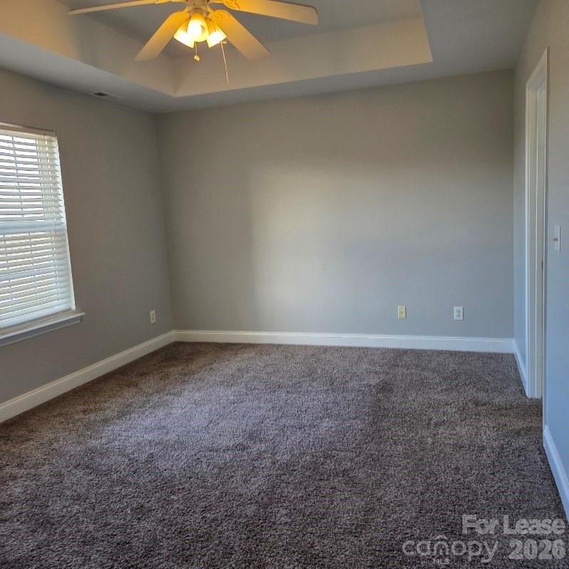5840 Timbertop Lane Charlotte, NC 28215 - Photo 12 of 34 a view of a big room with window and chandelier fan