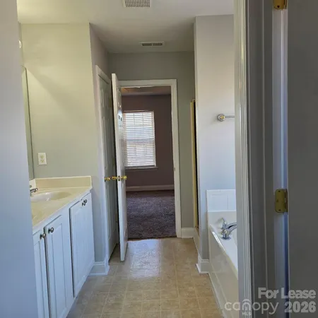 a view of bathroom with a sink and mirror