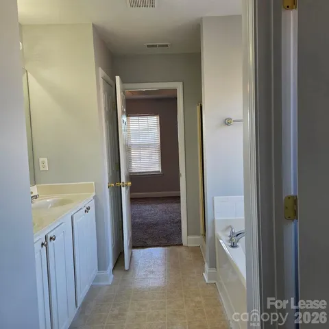 a view of bathroom with a sink and mirror