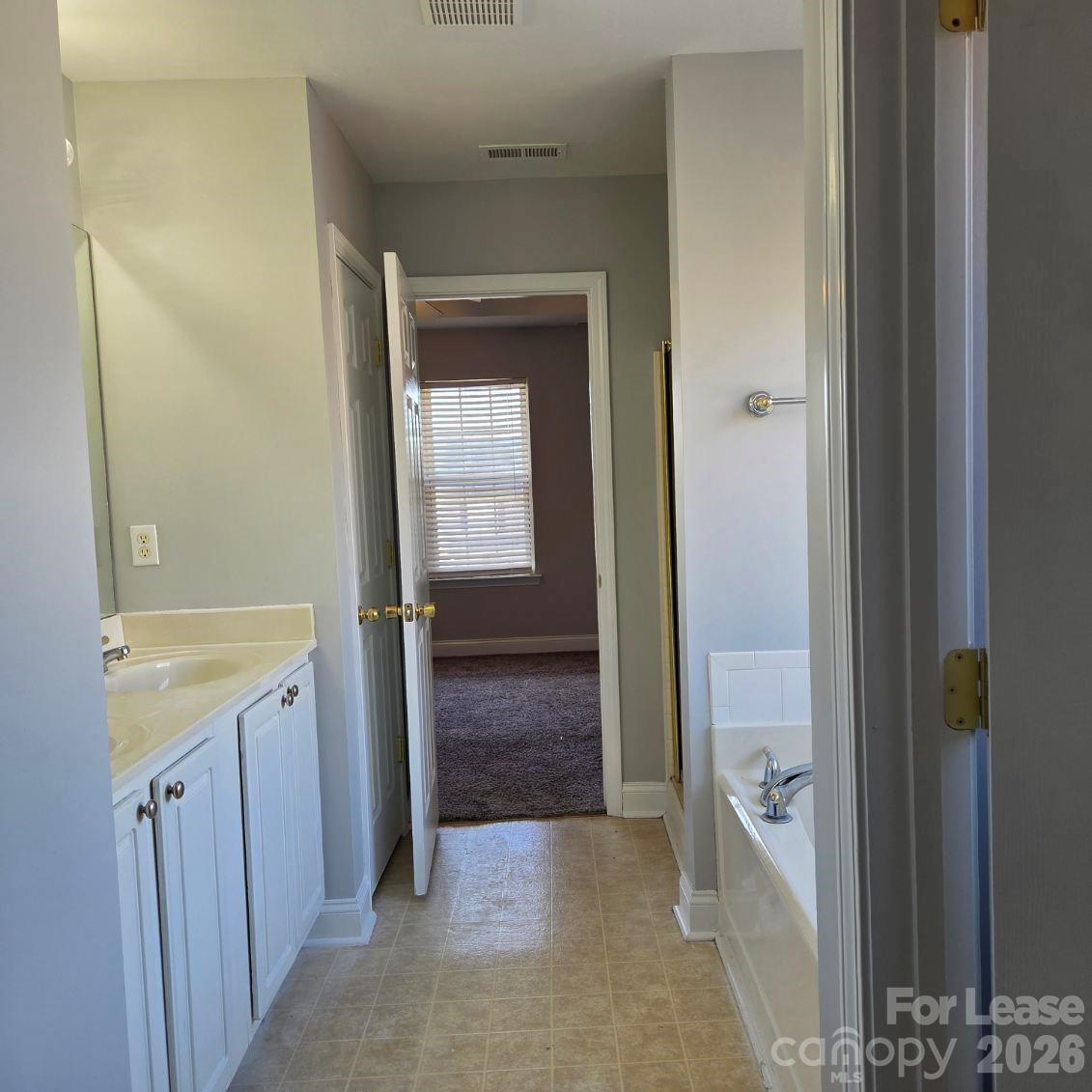 5840 Timbertop Lane Charlotte, NC 28215 - Photo 17 of 34 a view of bathroom with a sink and mirror