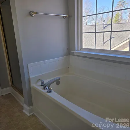 a bath tub sitting next to a window