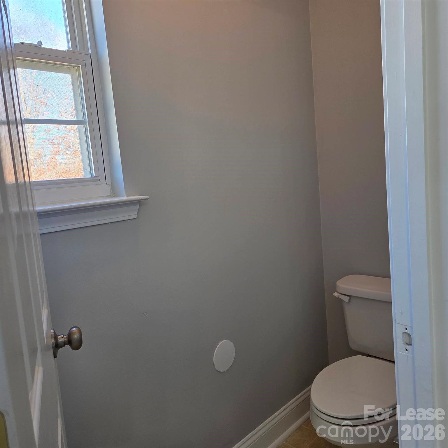 5840 Timbertop Lane Charlotte, NC 28215 - Photo 19 of 34 a white toilet sitting in a bathroom next to a window