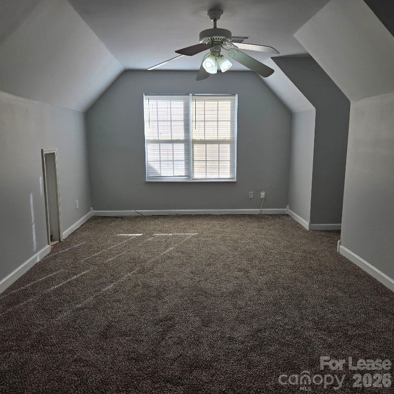 5840 Timbertop Lane Charlotte, NC 28215 - Photo 27 of 34 en empty room with windows and ceiling fan