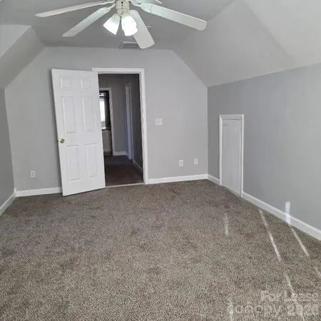 a view of an empty room and closet area