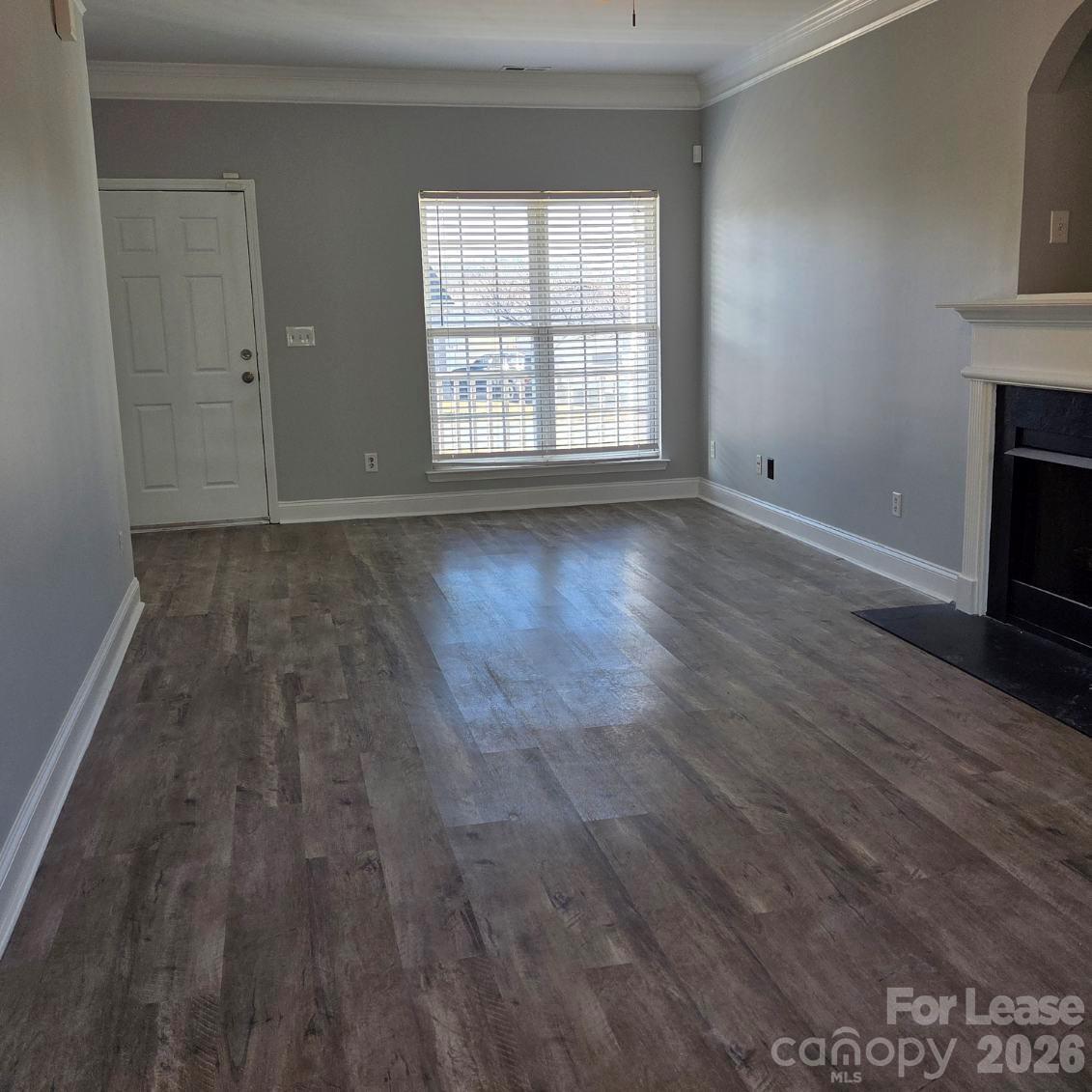 5840 Timbertop Lane Charlotte, NC 28215 - Photo 4 of 34 an empty room with wooden floor and windows