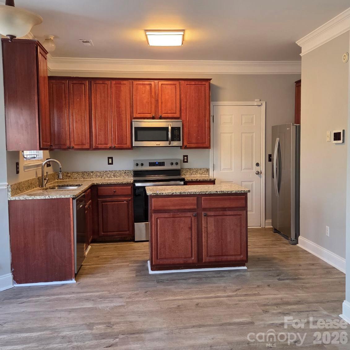 5840 Timbertop Lane Charlotte, NC 28215 - Photo 5 of 34 a kitchen with stainless steel appliances granite countertop a stove a sink dishwasher a refrigerator and a microwave oven