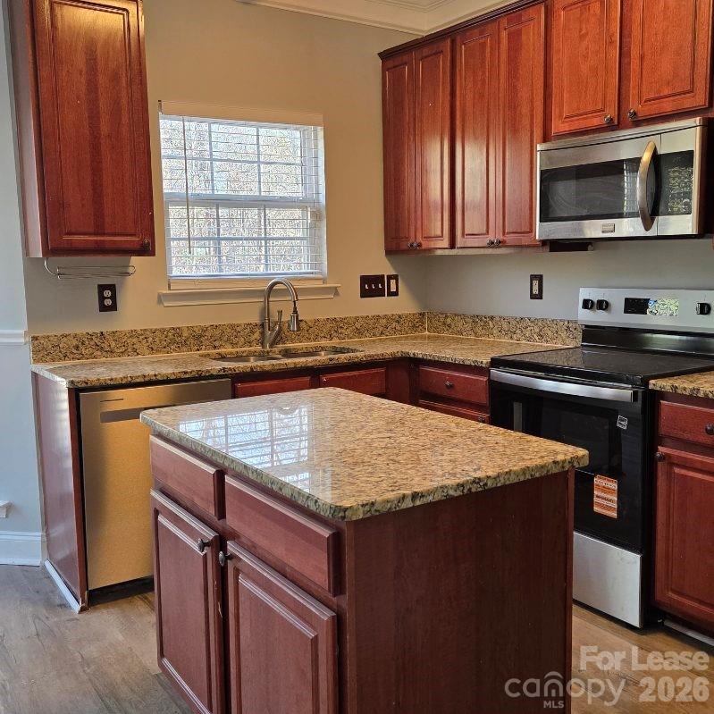5840 Timbertop Lane Charlotte, NC 28215 - Photo 7 of 34 a kitchen with stainless steel appliances granite countertop wooden cabinets sink and stove top oven
