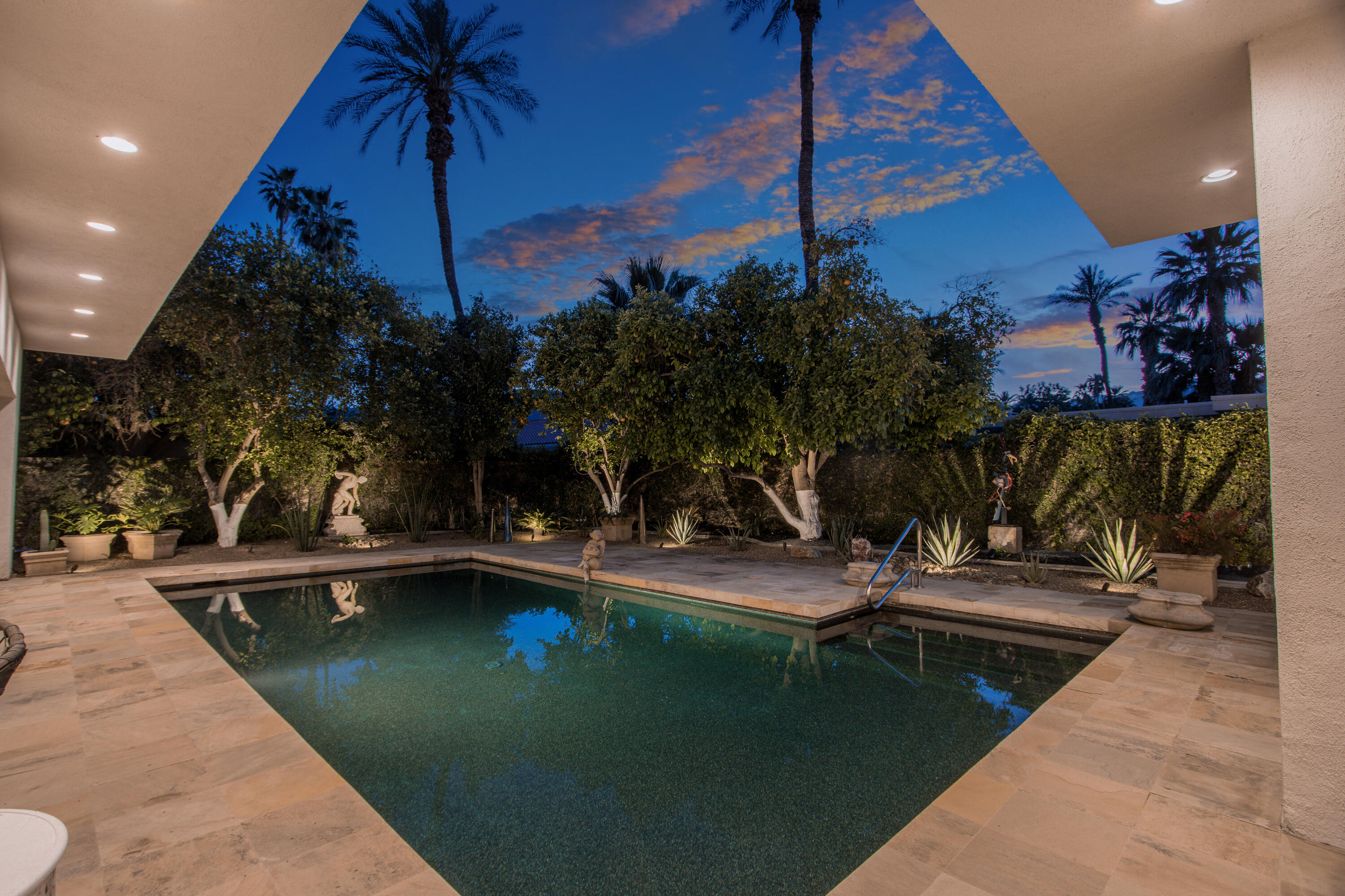 37355 Palm View Road Rancho Mirage, CA 92270 - Photo 41 of 49 a view of a swimming pool with a table and chairs under an umbrella