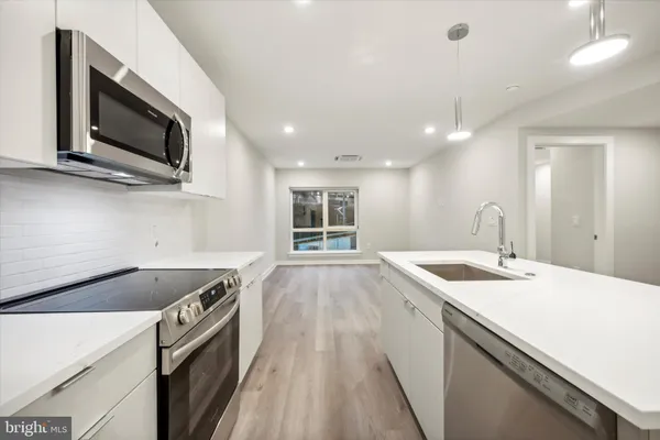 a kitchen with a sink and a microwave