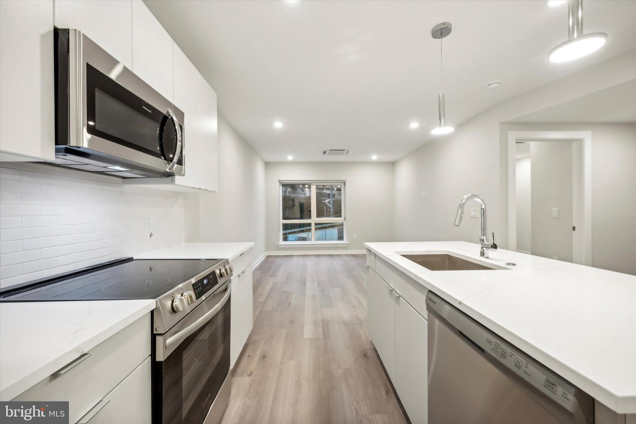 3449 Scotts Lane, Unit B309 Philadelphia, PA 19129 - Photo 2 of 6 a kitchen with a sink and a microwave