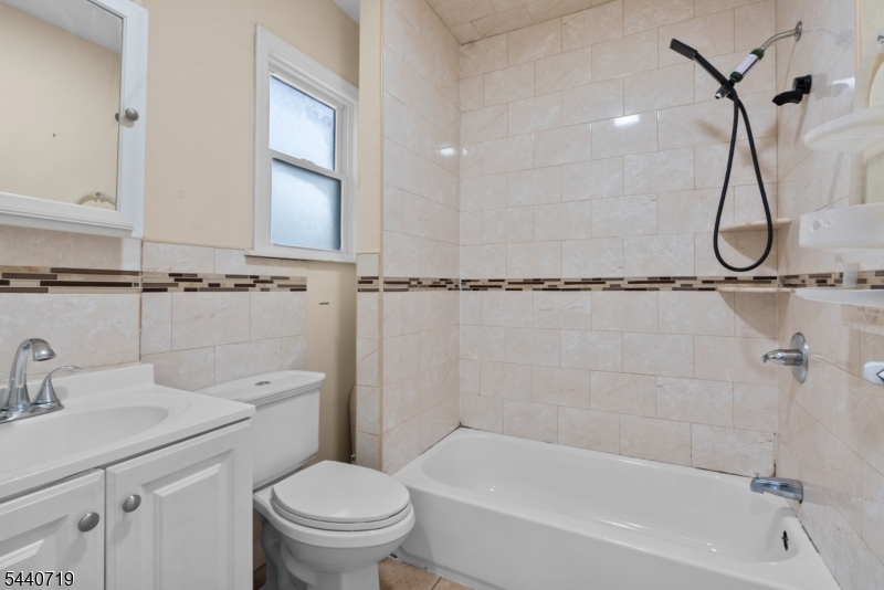 136 Smith Street Elizabeth, NJ 07201 - Photo 23 of 38 a bathroom with a sink a toilet and shower