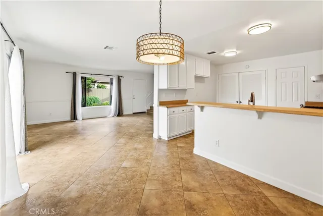a kitchen with cabinets appliances and a sink