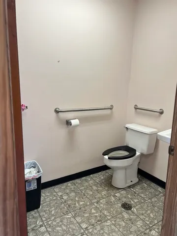 a white toilet sitting next to a white sink
