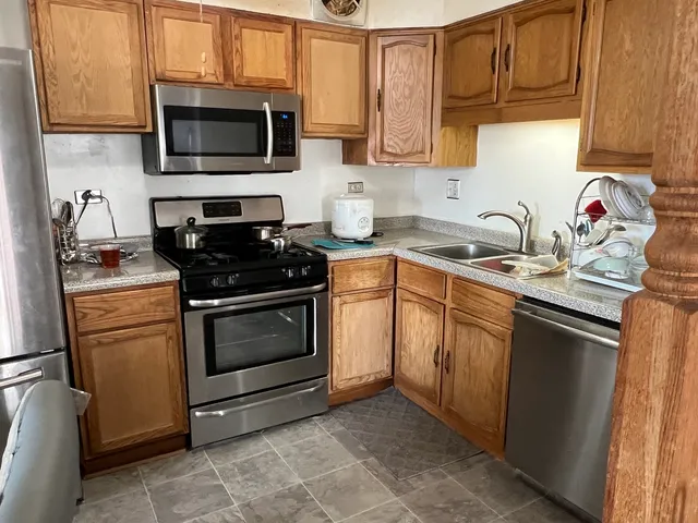 a kitchen with a sink stove and microwave