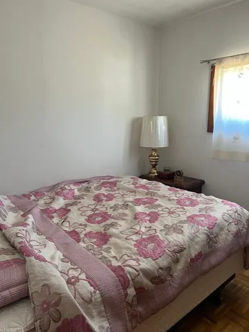 a bedroom with a bed and a lamp