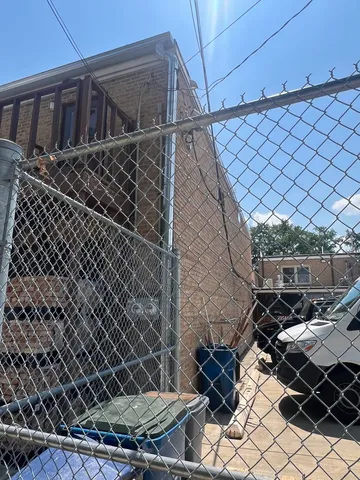 a backyard of a house with parking space