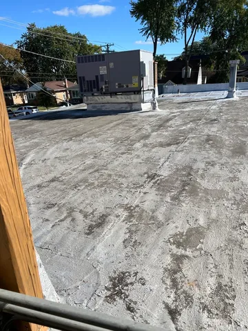 a view of car parked on the side of a street