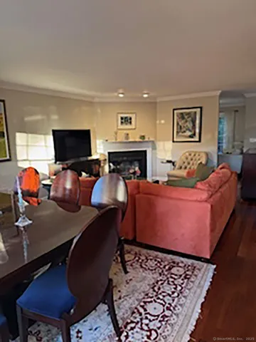 a room with furniture a flat screen tv and paintings on the wall