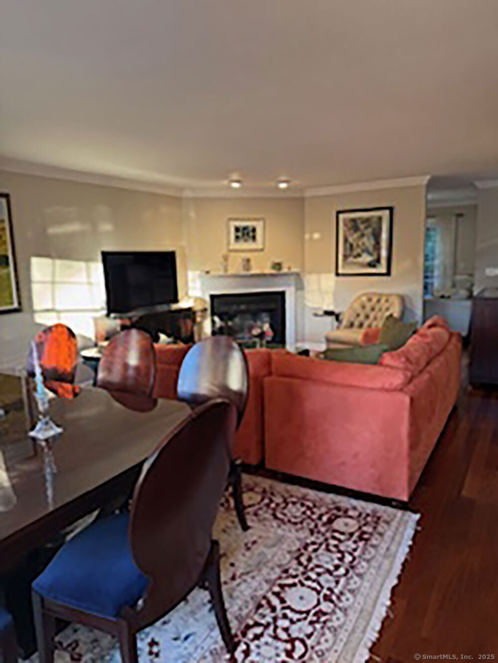 123 Governor Trumbull Way, Unit 123 Trumbull, CT 06611 - Photo 3 of 8 a room with furniture a flat screen tv and paintings on the wall