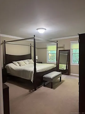 a bedroom with a bed and window