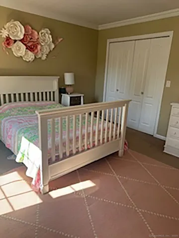 a view of a bedroom with wooden floor