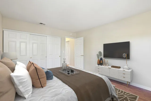 a bedroom with a bed and a flat screen tv