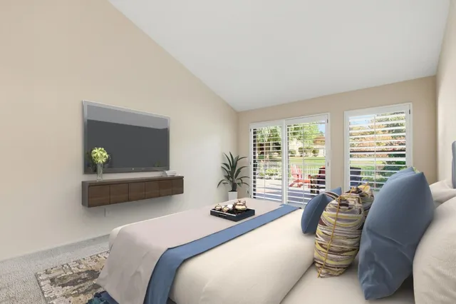 a bedroom with a bed and a couch