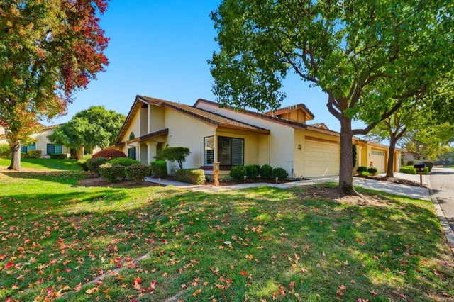 a view of a house with backyard and sitting area
