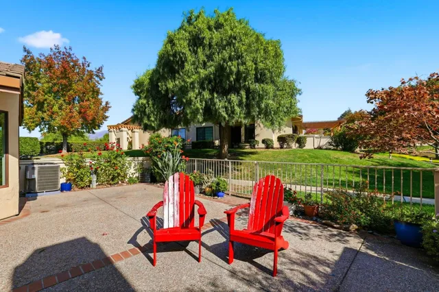 a view of a chair and tables in patio of the house