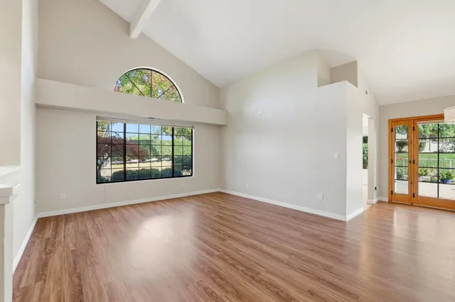 a view of a room with wooden floor and a sink