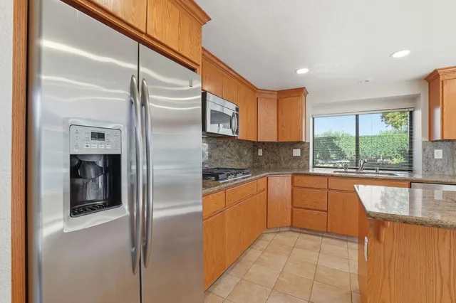 a kitchen with stainless steel appliances granite countertop a sink and cabinets