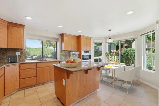 a kitchen with a sink and chairs