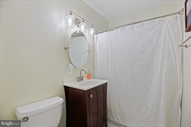a bathroom with a sink a toilet and mirror