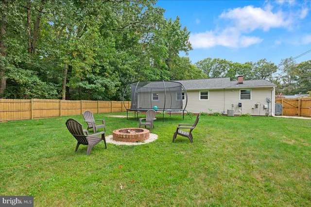 a view of a house with backyard and a sitting area