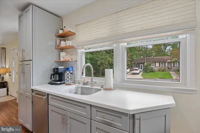 a kitchen with a sink appliances and a window
