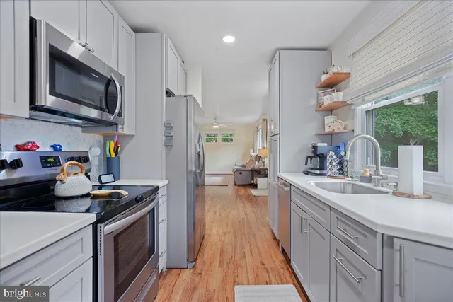 a kitchen with a sink appliances and cabinets