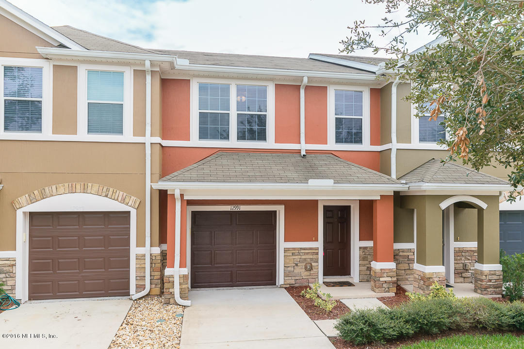 12991 Spring Rain Road Jacksonville, FL 32258 - Photo 1 of 23 a front view of a house with a yard