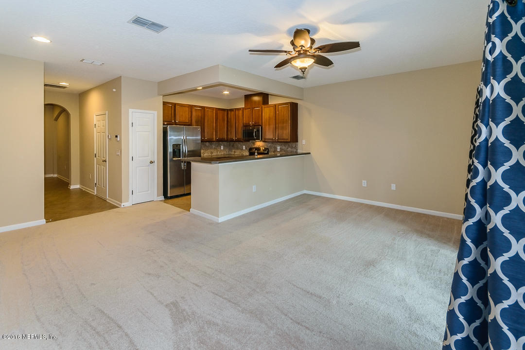 12991 Spring Rain Road Jacksonville, FL 32258 - Photo 14 of 23 a view of a kitchen with a sink and a refrigerator