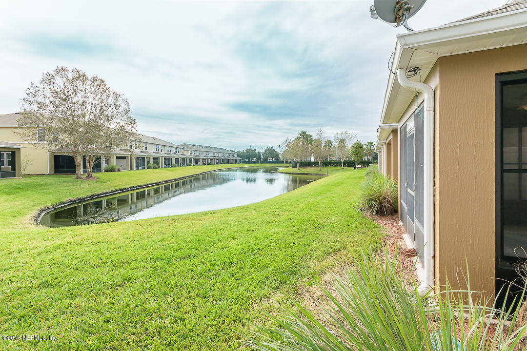 12991 Spring Rain Road Jacksonville, FL 32258 - Photo 19 of 23 a view of a house with a big yard and potted plants