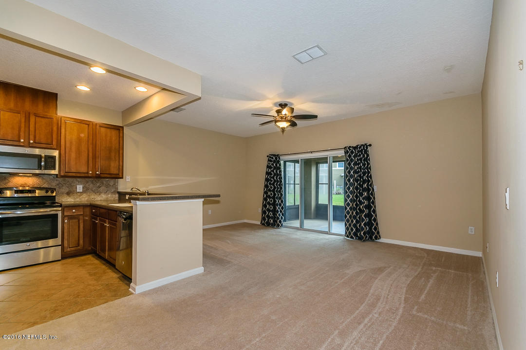 12991 Spring Rain Road Jacksonville, FL 32258 - Photo 3 of 23 a view of an empty room with kitchen and window