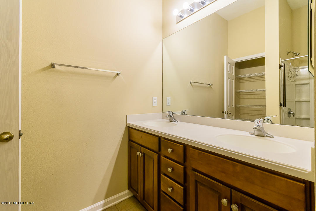 12991 Spring Rain Road Jacksonville, FL 32258 - Photo 5 of 23 a bathroom with a sink and a mirror