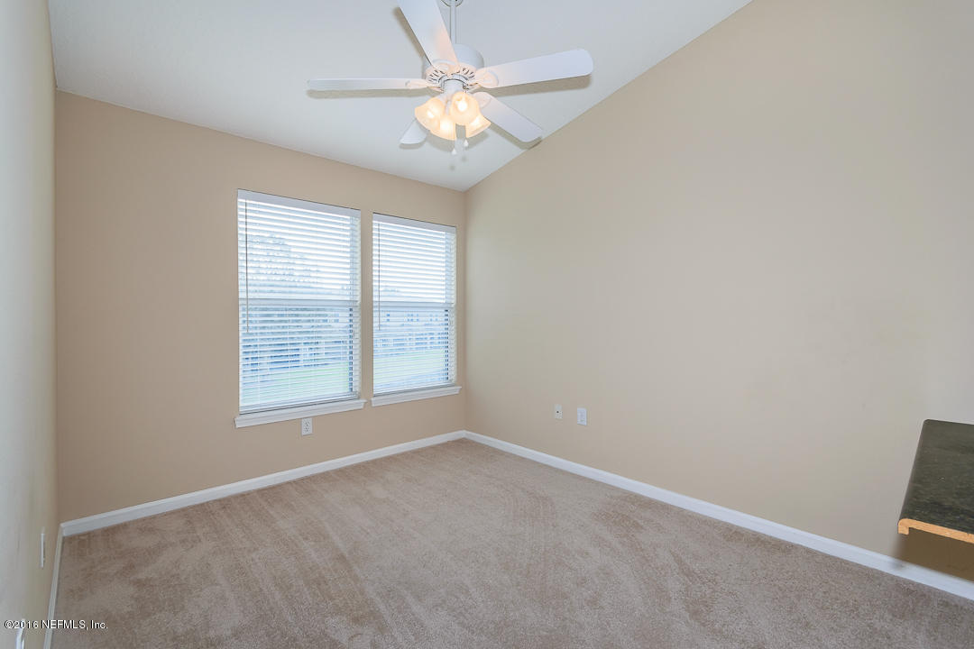 12991 Spring Rain Road Jacksonville, FL 32258 - Photo 9 of 23 an empty room with a window and a fan