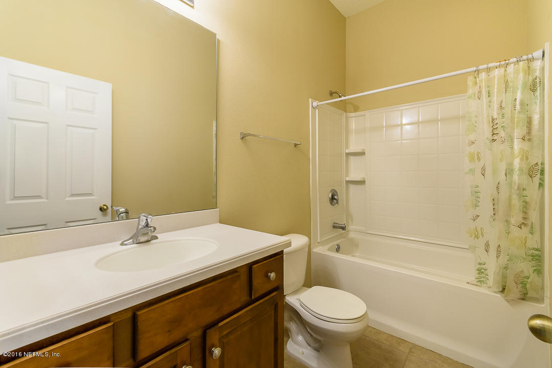 12991 Spring Rain Road Jacksonville, FL 32258 - Photo 10 of 23 a bathroom with a sink a toilet and shower